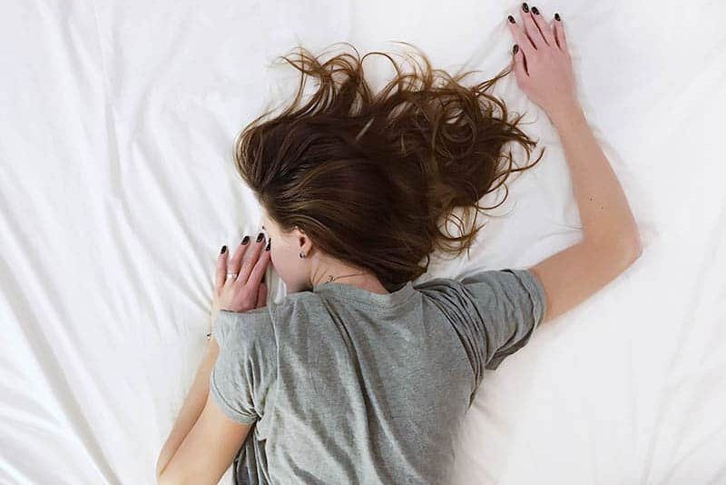 la dona està estirada al llit