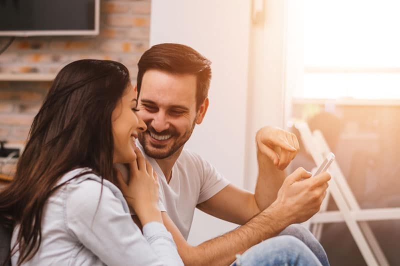 lächelnder Mann, der mit Frau spricht