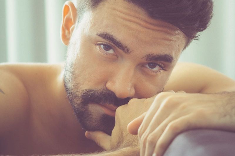 homem pensativo com barba em close-up fotografia seminu olhando para a câmera